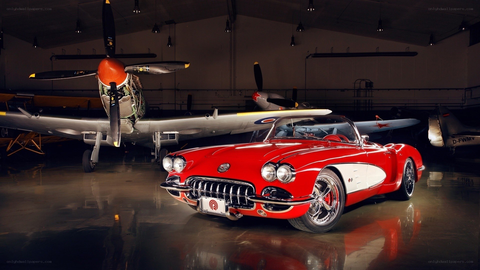 Red Corvette with vintage planes