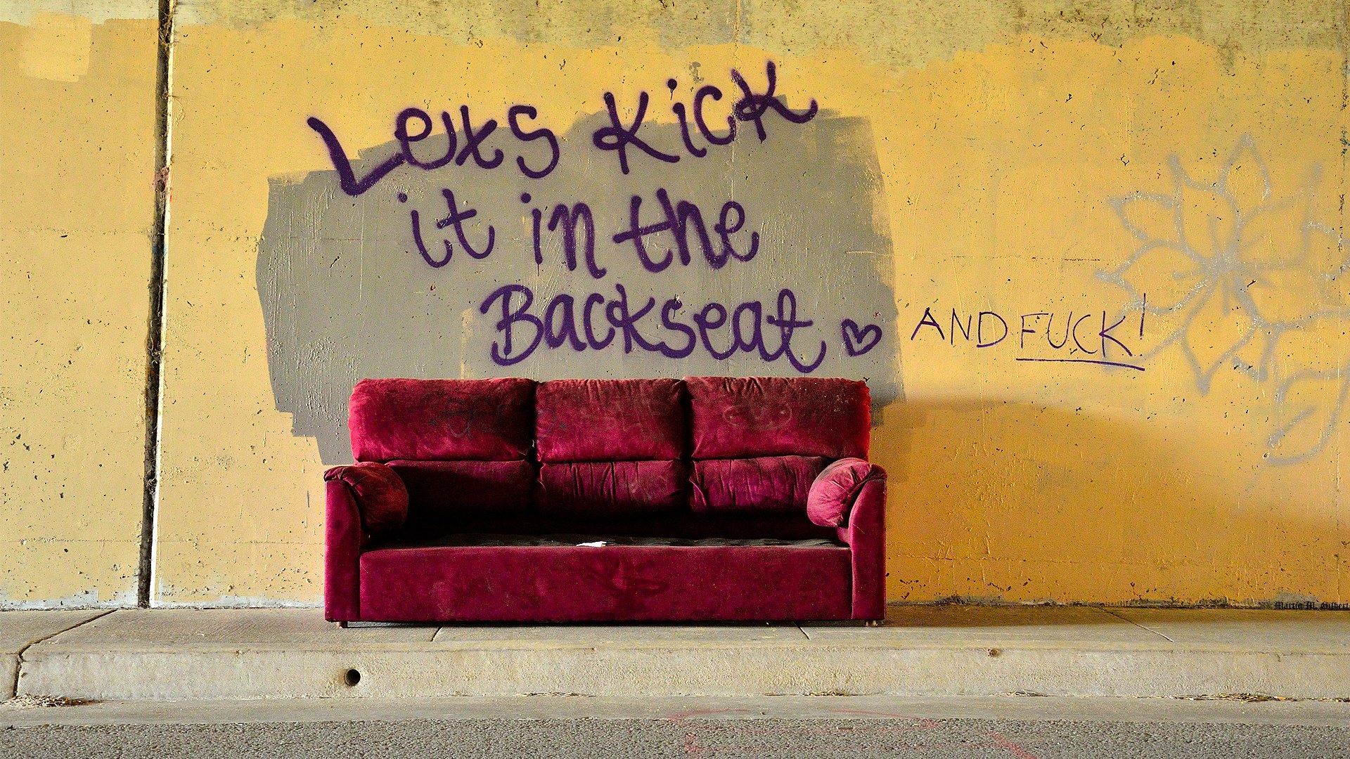 Red couch with graffiti