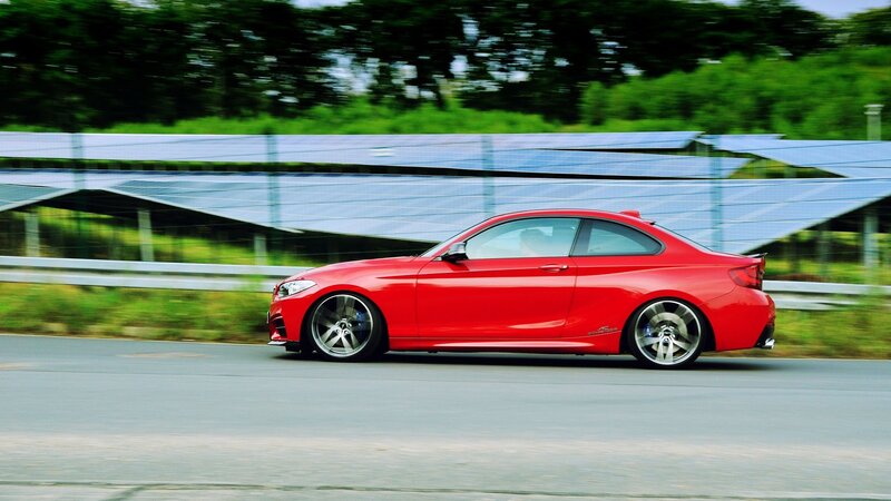 Red Coupe Car — Dynamic, Afternoon, Photograph, Solar Panels
