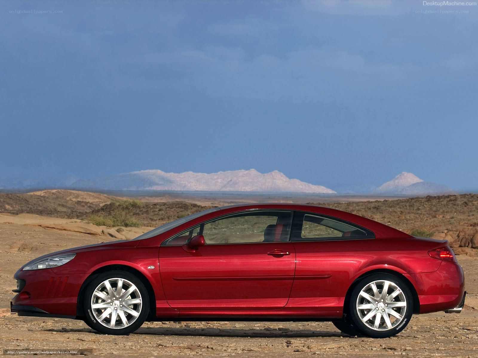 Red coupe in desert landscape