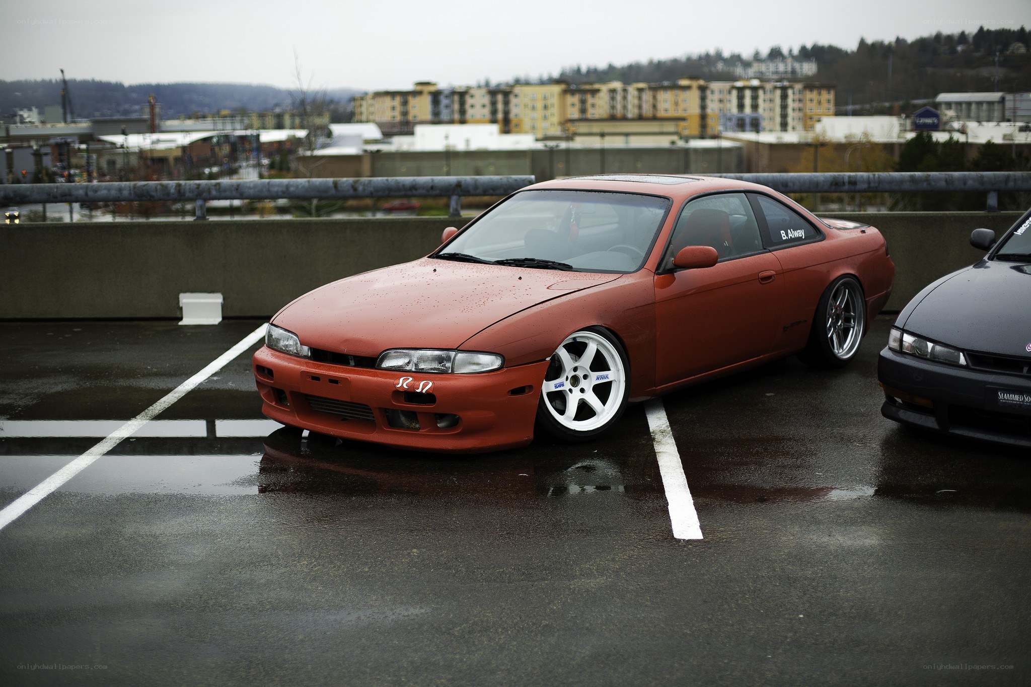 Red coupe in parking garage