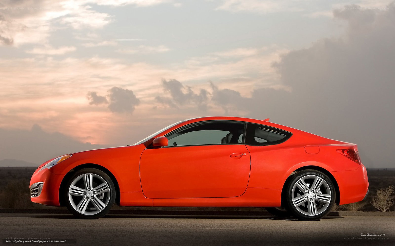 Red coupe on desert road