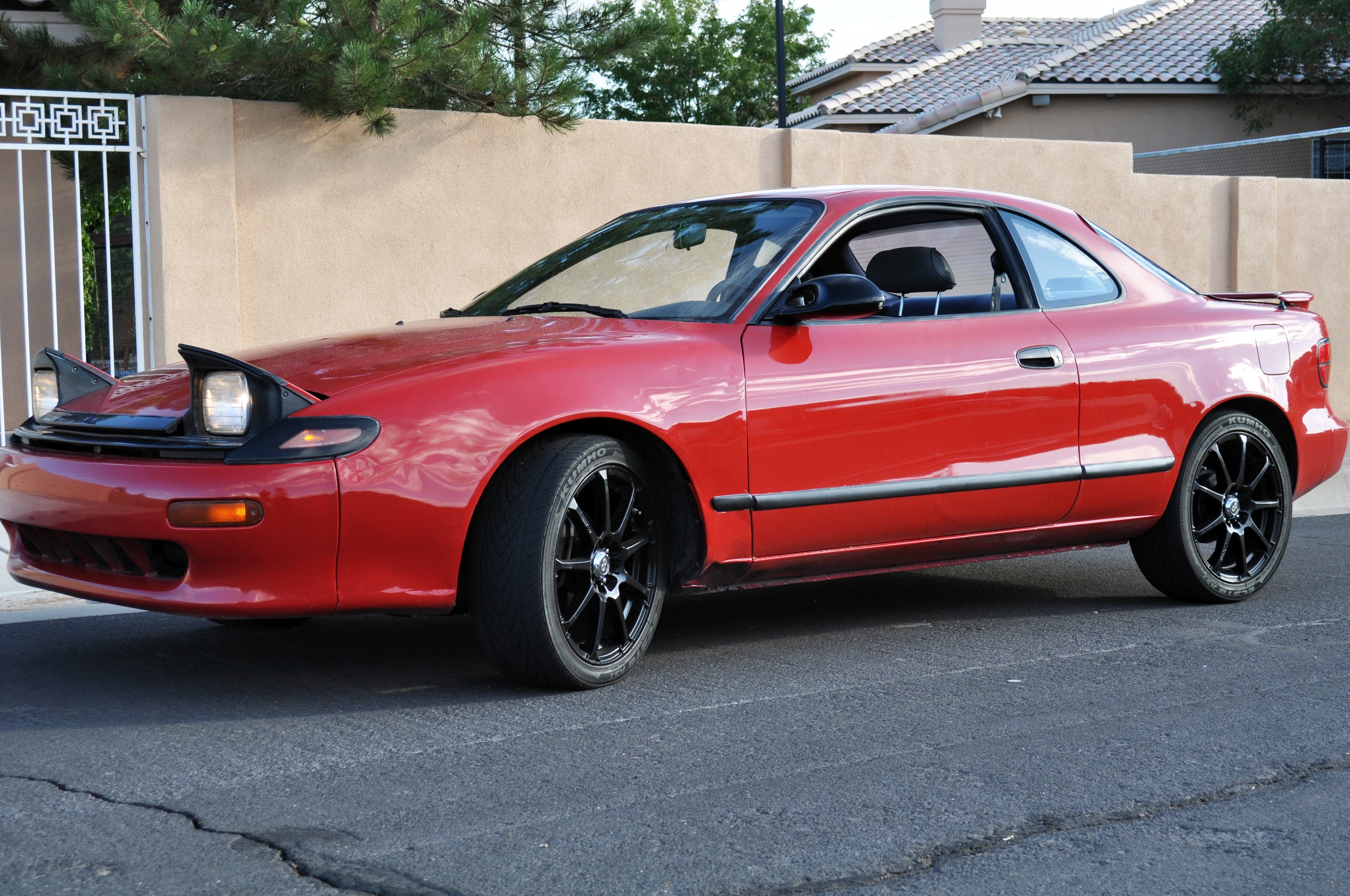 red coupe parked on street