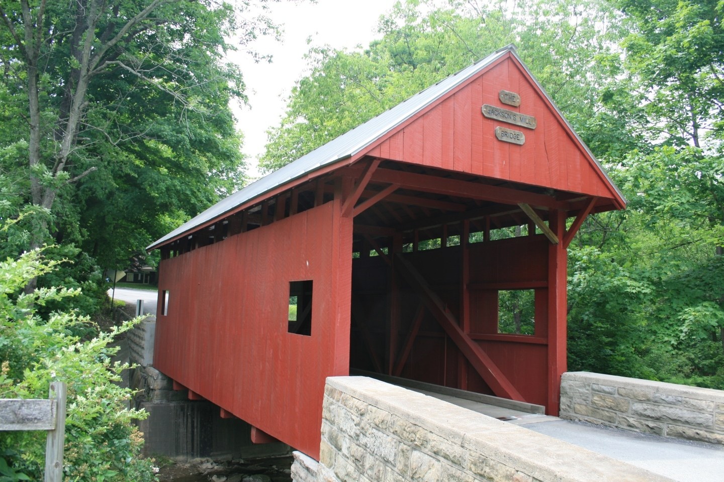 Red covered bridge in forest