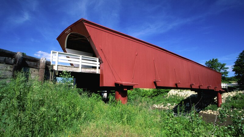 Red covered bridge over river