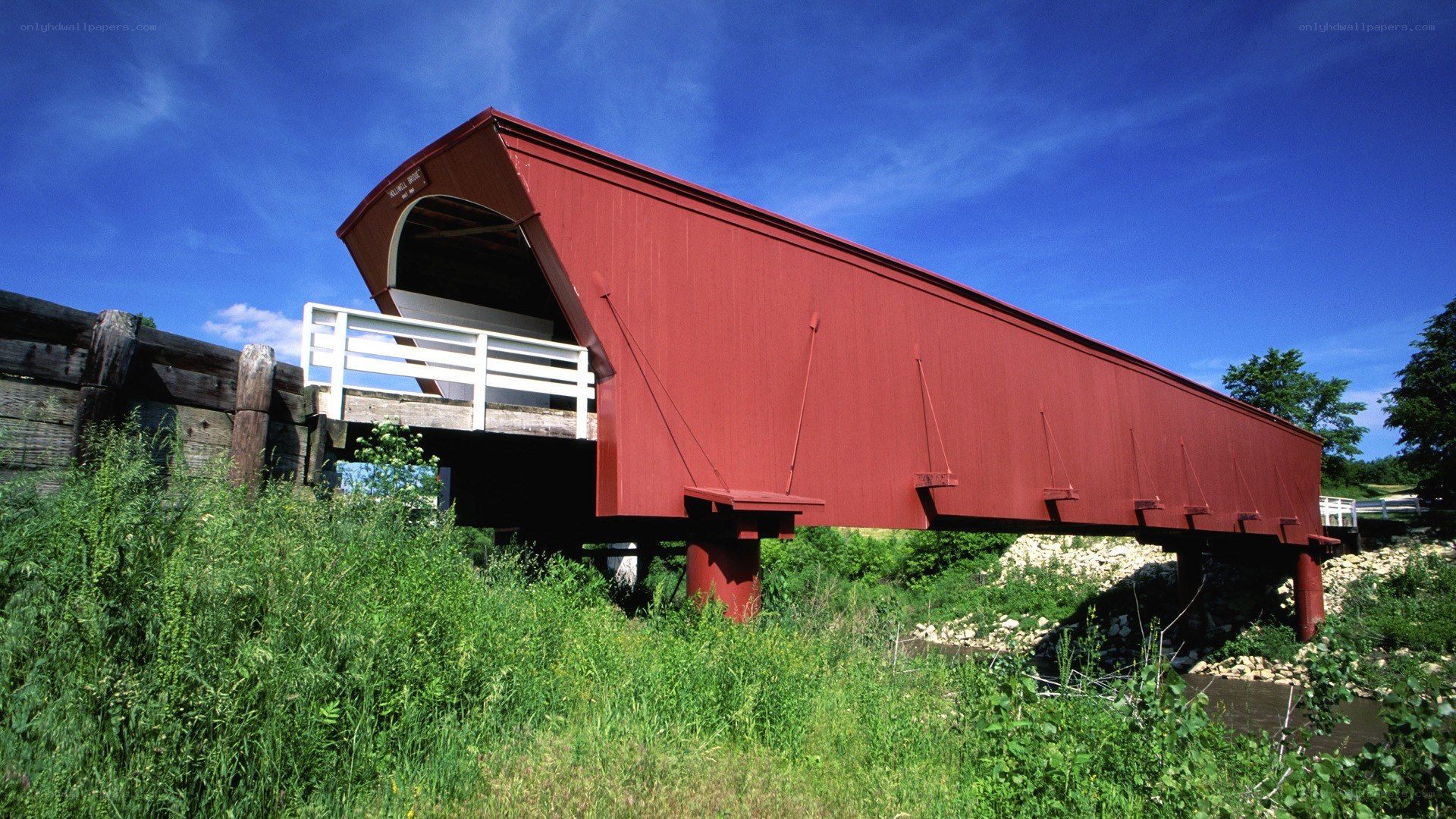 Red covered bridge over river