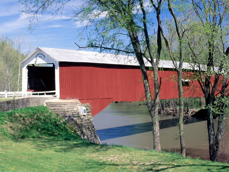Red covered bridge over river
