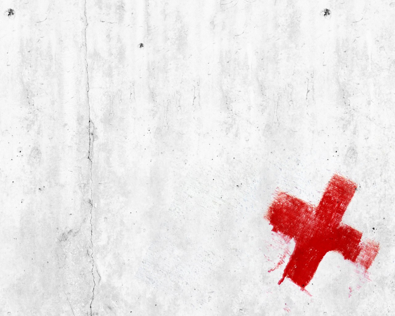 Red cross on concrete wall