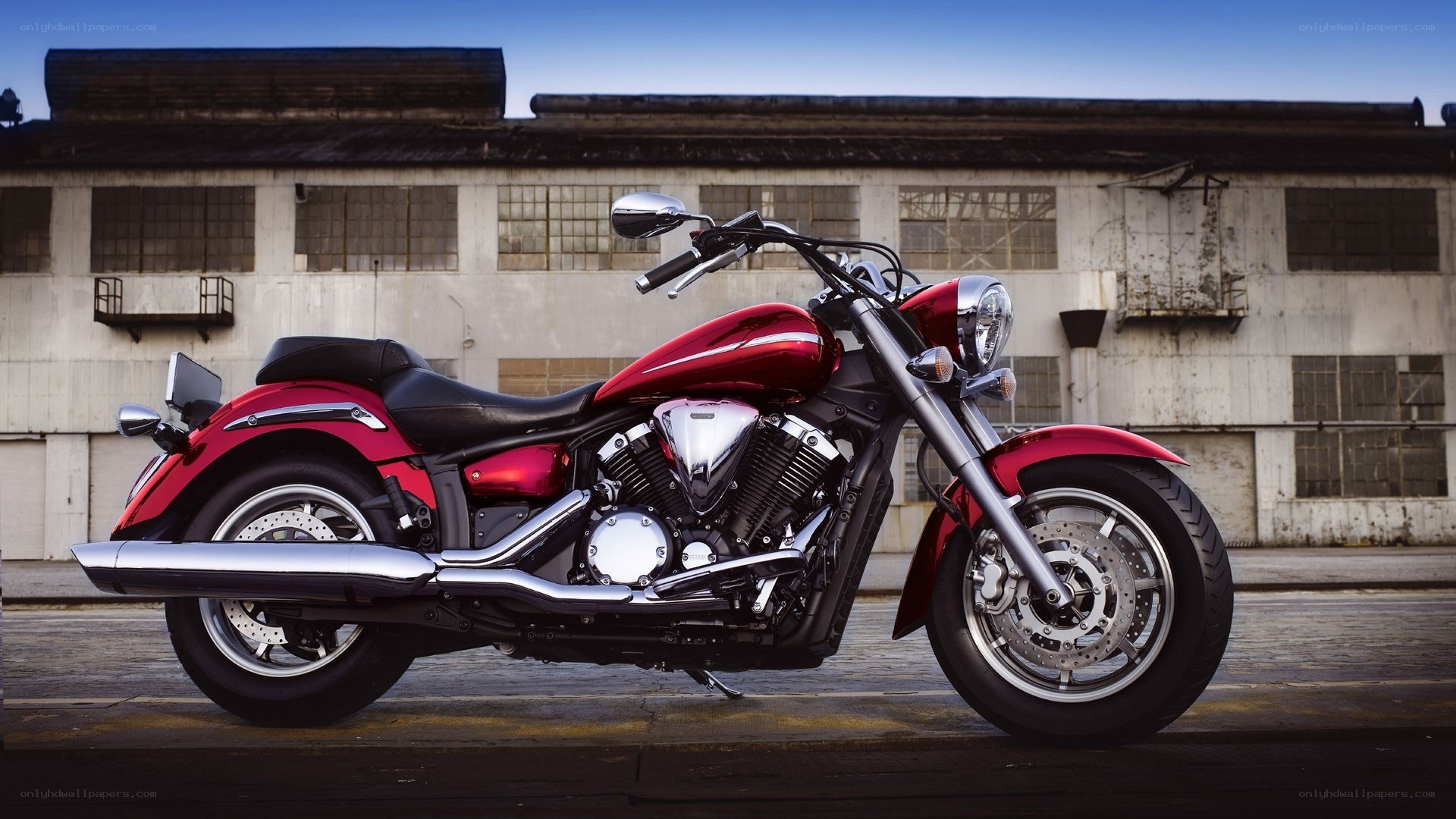 red cruiser motorcycle in industrial setting