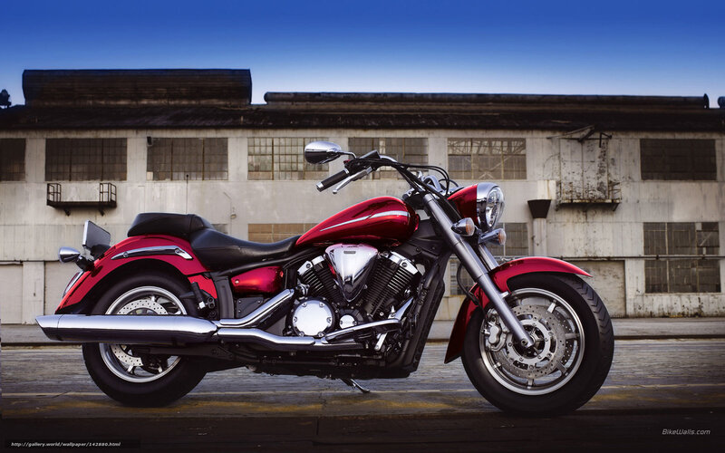Red cruiser motorcycle in industrial setting
