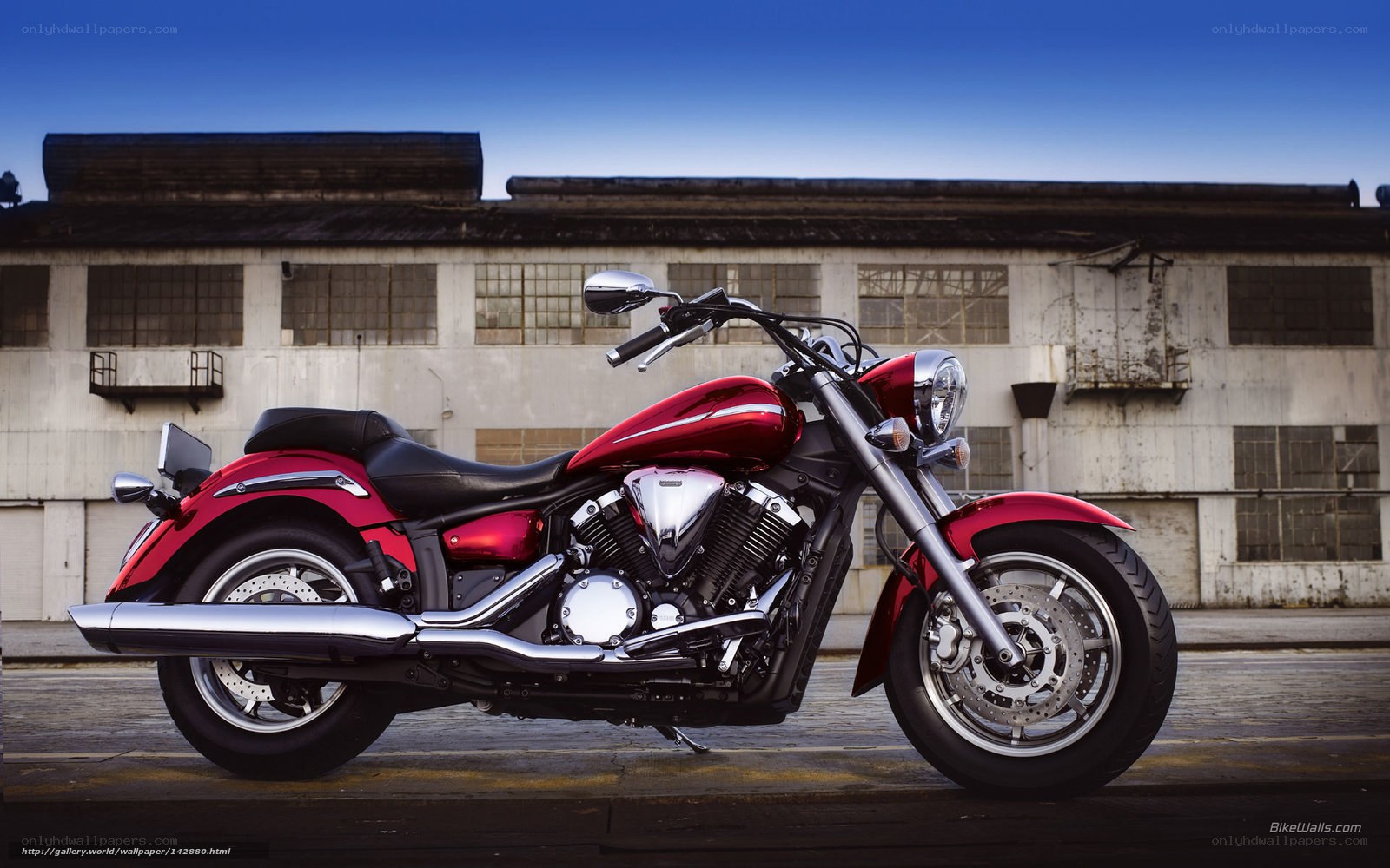 Red cruiser motorcycle in industrial setting