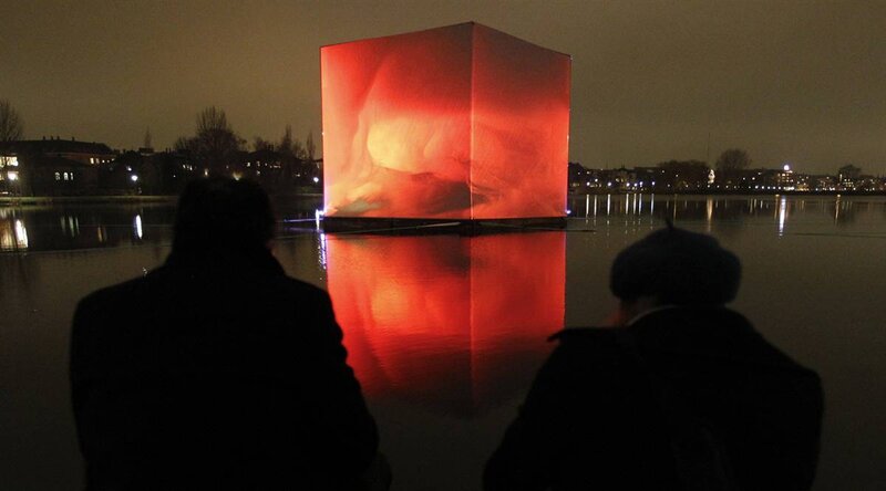 Red cube art installation at night