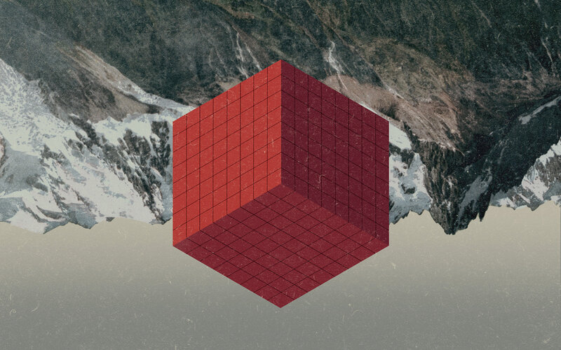 Red cube over mountains