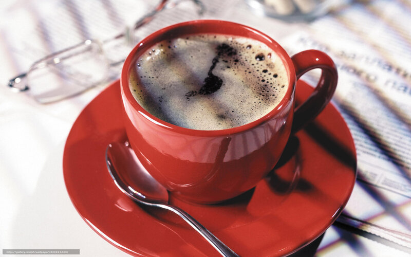 Red cup of coffee on saucer
