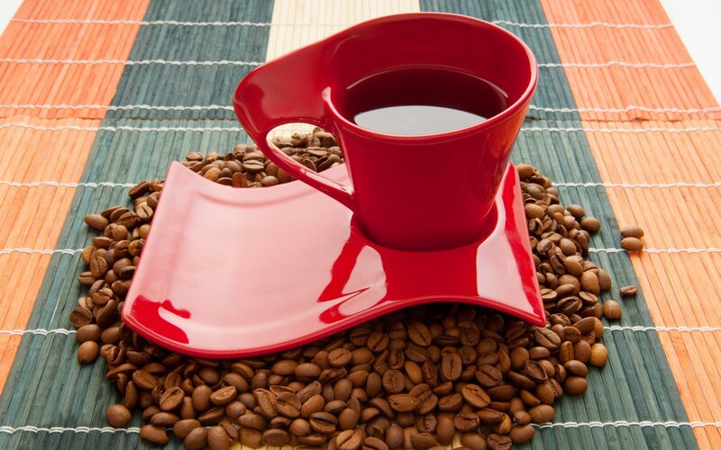Red cup on coffee beans
