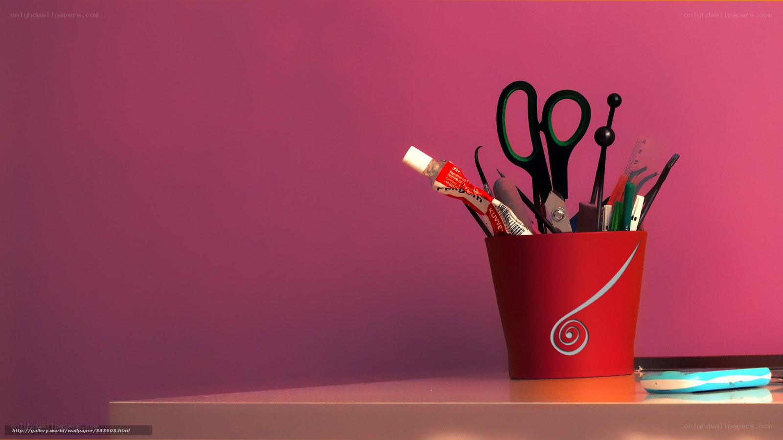 Red cup with office supplies
