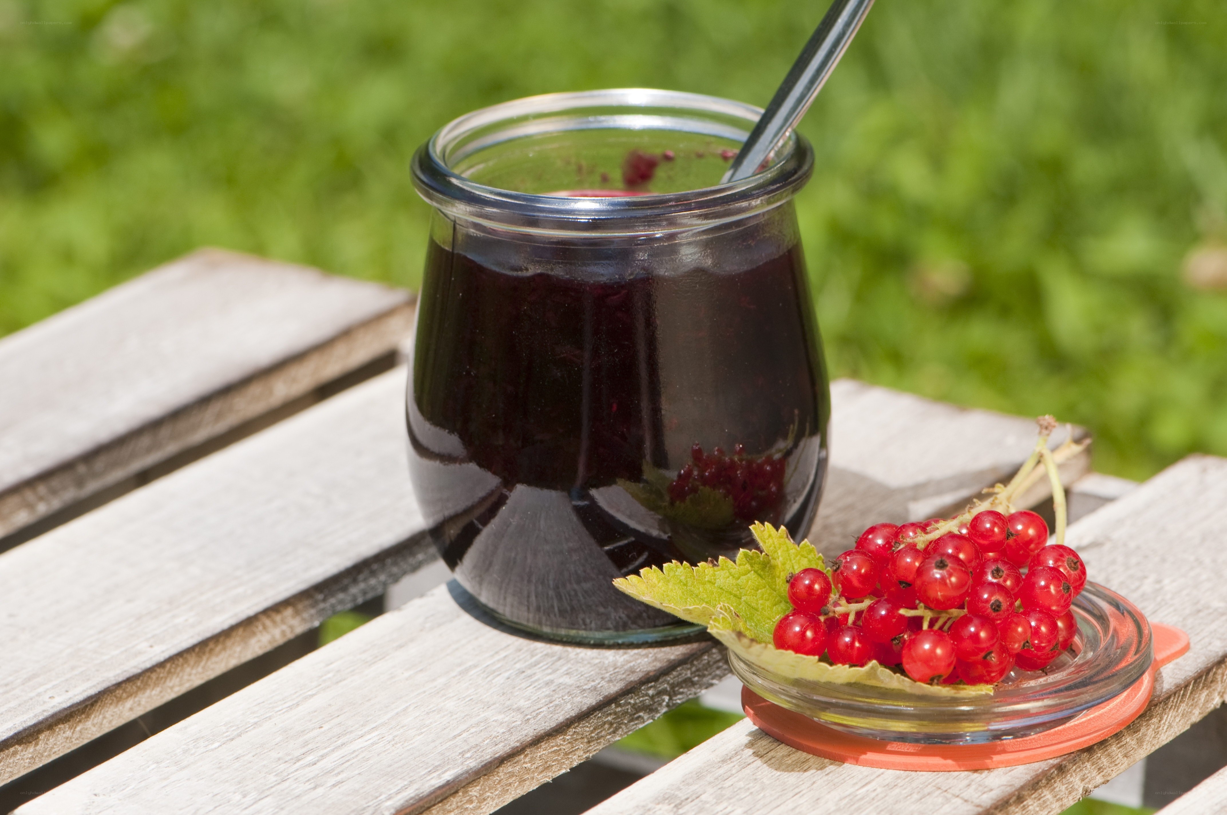 Red currant jam on a wooden table