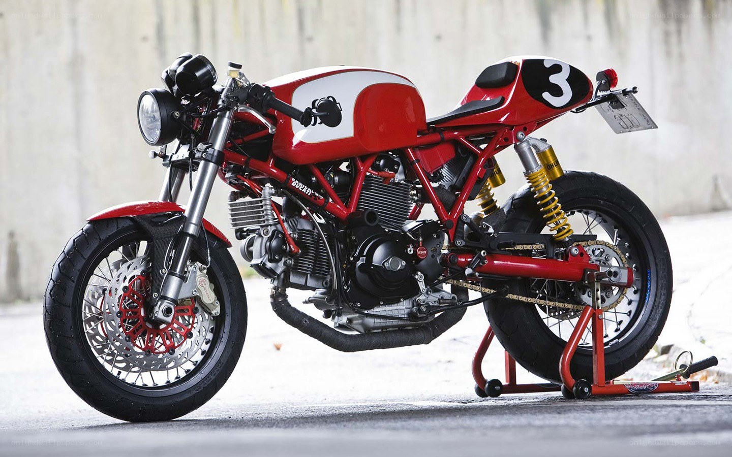red custom motorcycle with number three