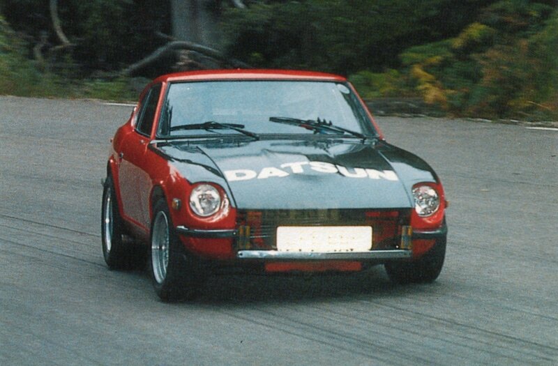 Red Datsun race car on track