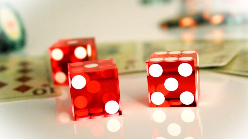 Red dice on a reflective surface
