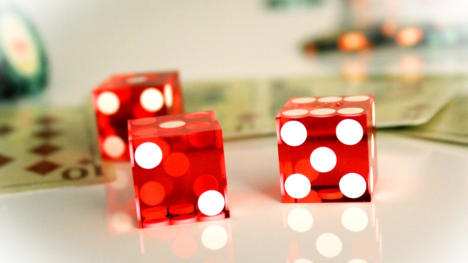 Red dice on a reflective surface