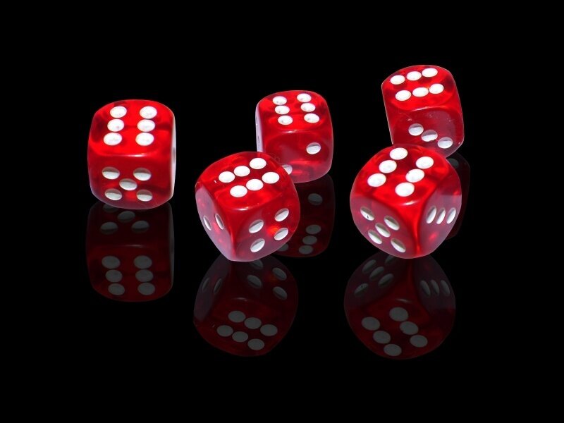 Red Dice on Black Surface — Dramatic