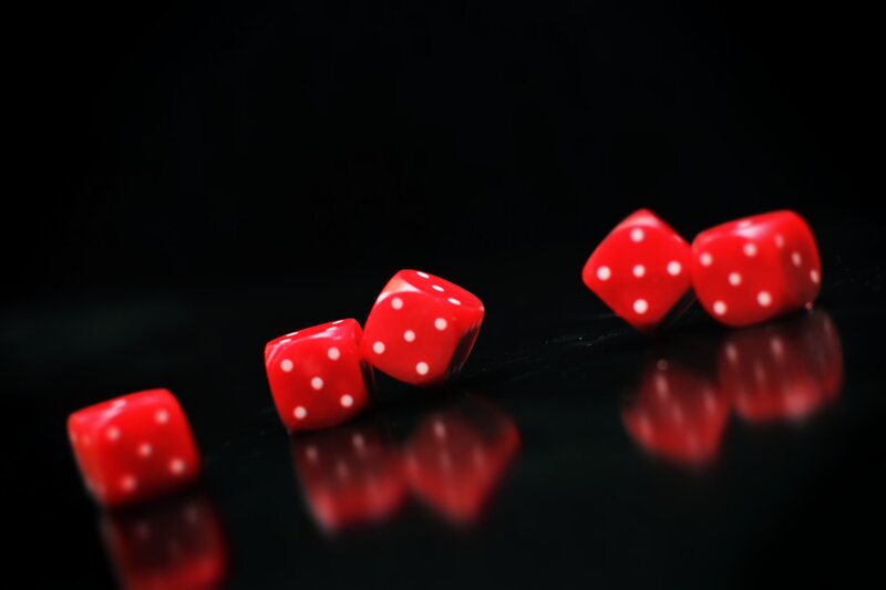Red Dice on Black Surface