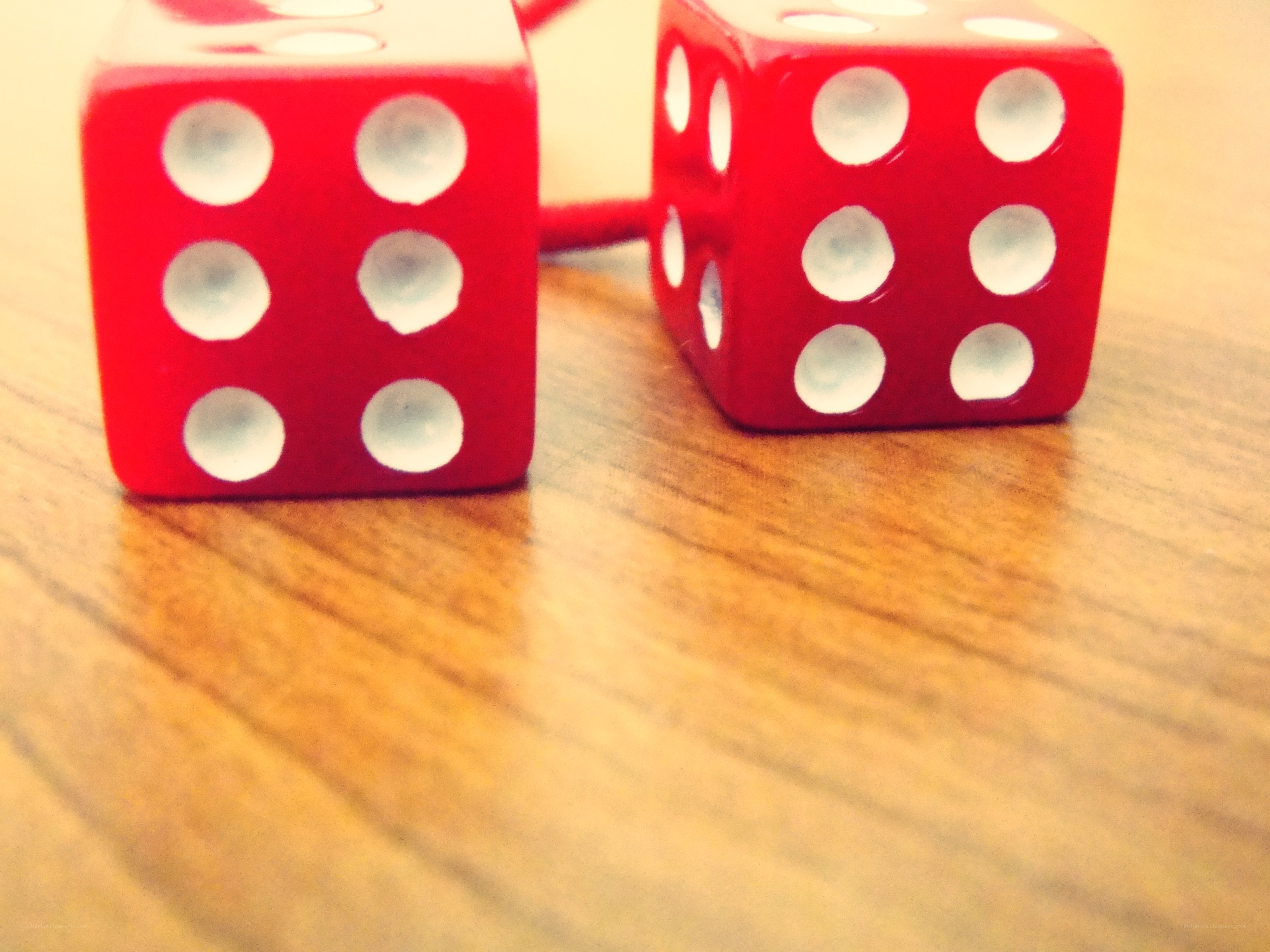 red dice on wooden surface
