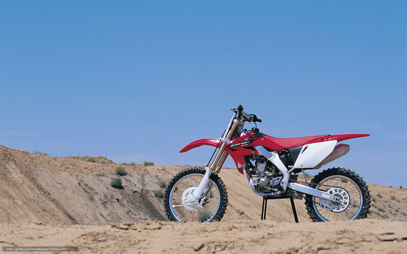 Red dirt bike on desert hill