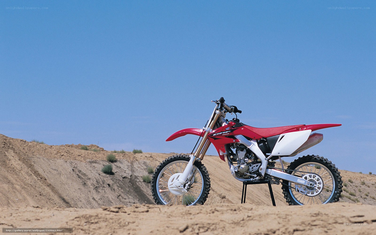 Red dirt bike on desert hill