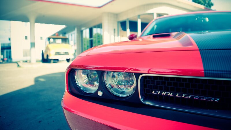 Red Dodge Challenger at gas station