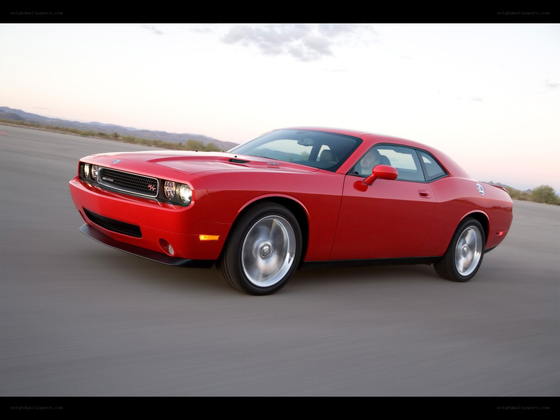 Red Dodge Challenger in motion