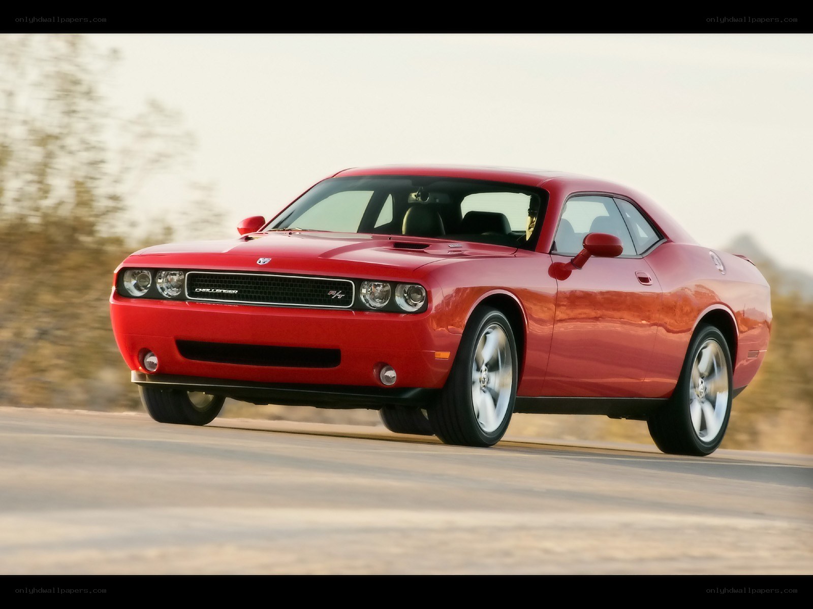 Red Dodge Challenger in motion