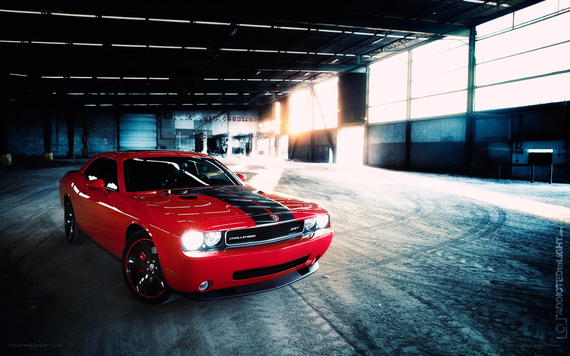Red Dodge Challenger in warehouse