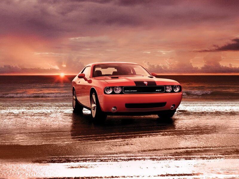 Red Dodge Challenger on beach