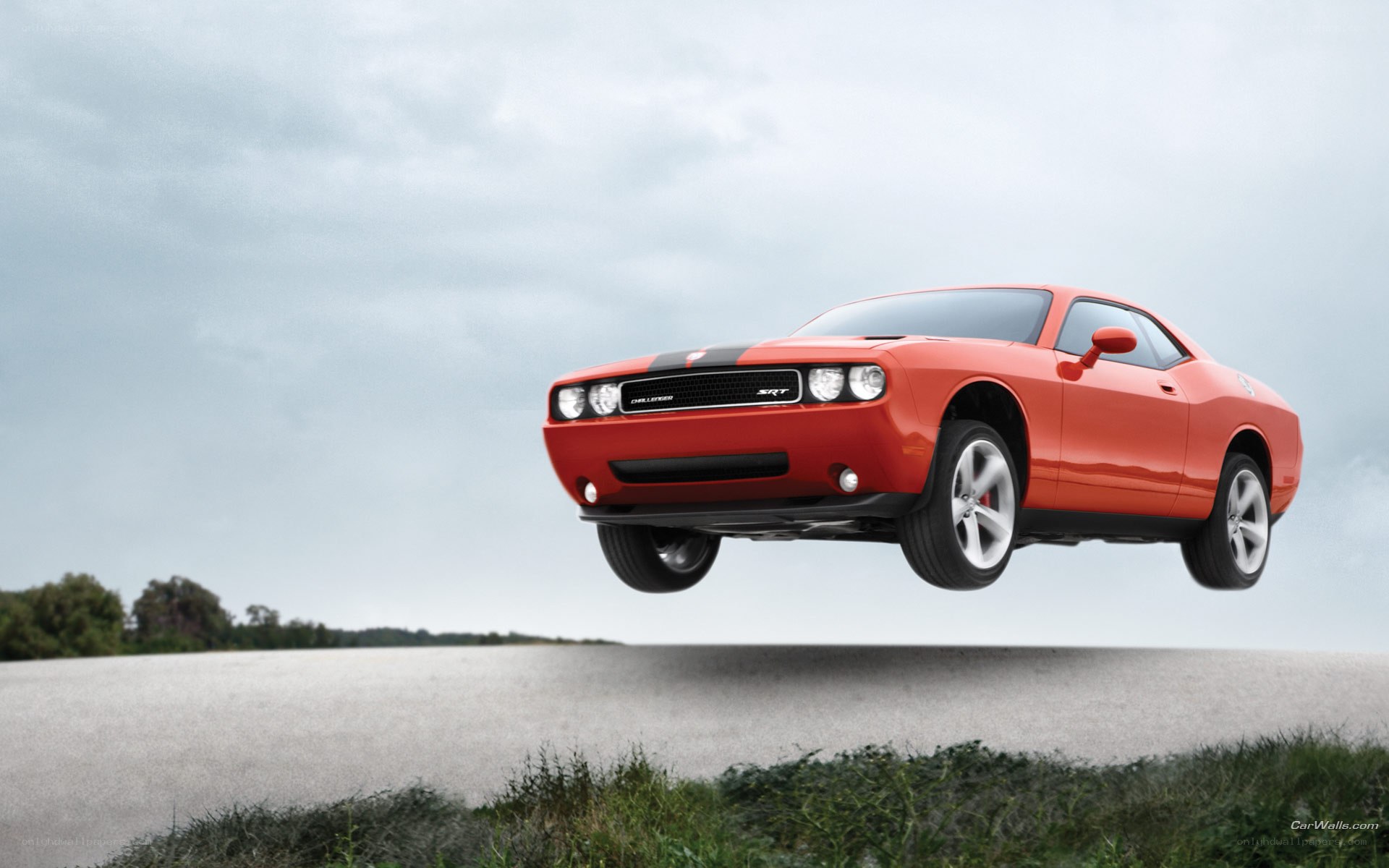 Red Dodge Challenger SRT in mid-air