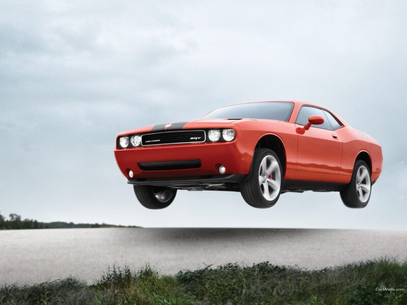 Red Dodge Challenger SRT in mid-air