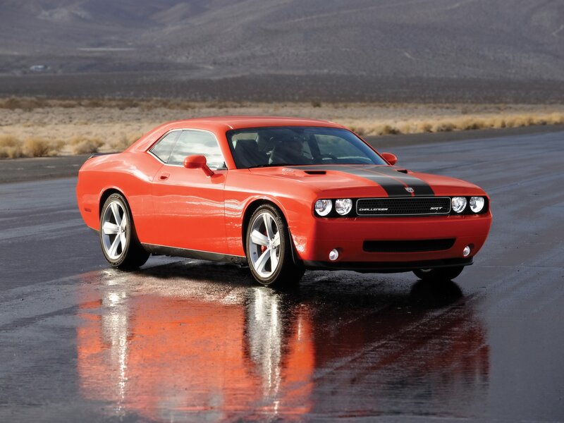 Red Dodge Challenger SRT on wet road