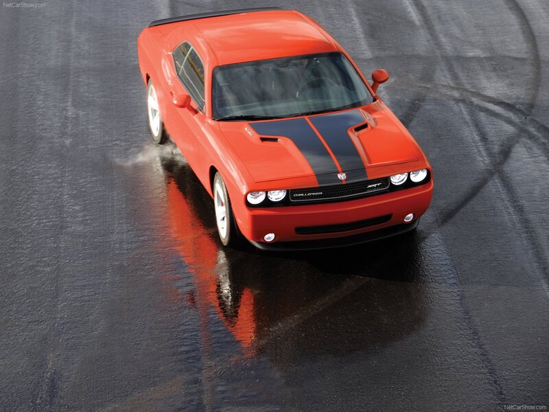 Red Dodge Challenger SRT on wet track