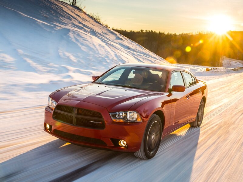 Red Dodge Charger on snowy road