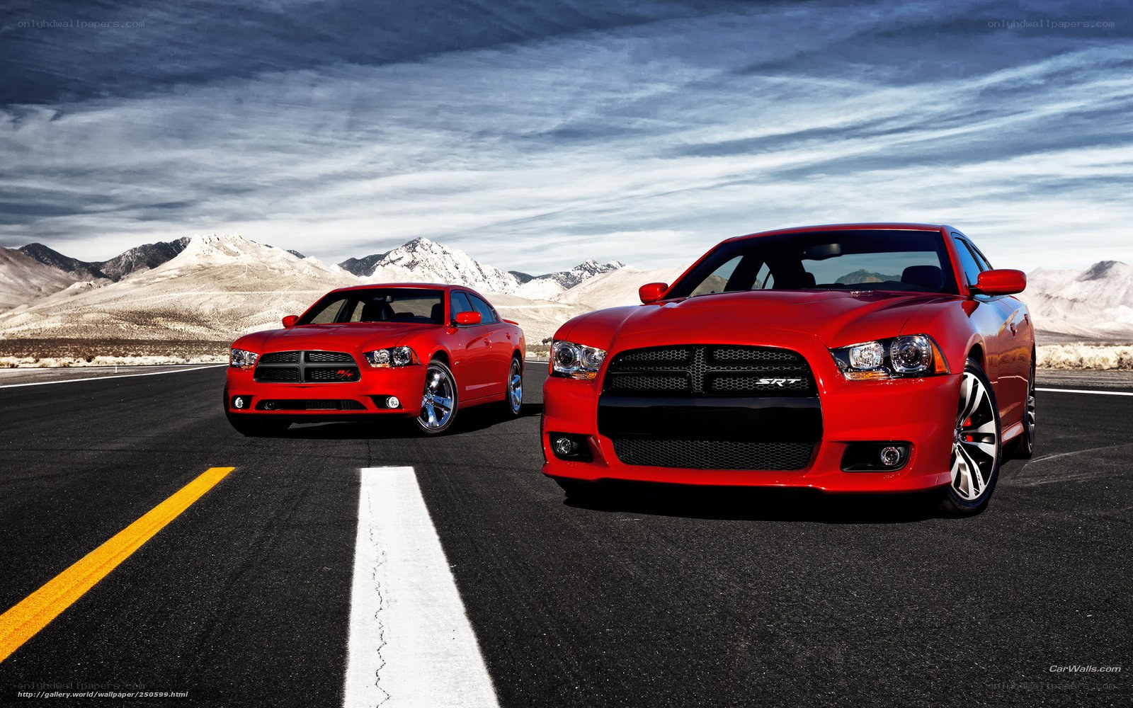 Red Dodge Chargers on desert road