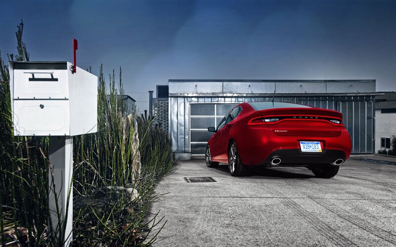 Red Dodge Dart in driveway