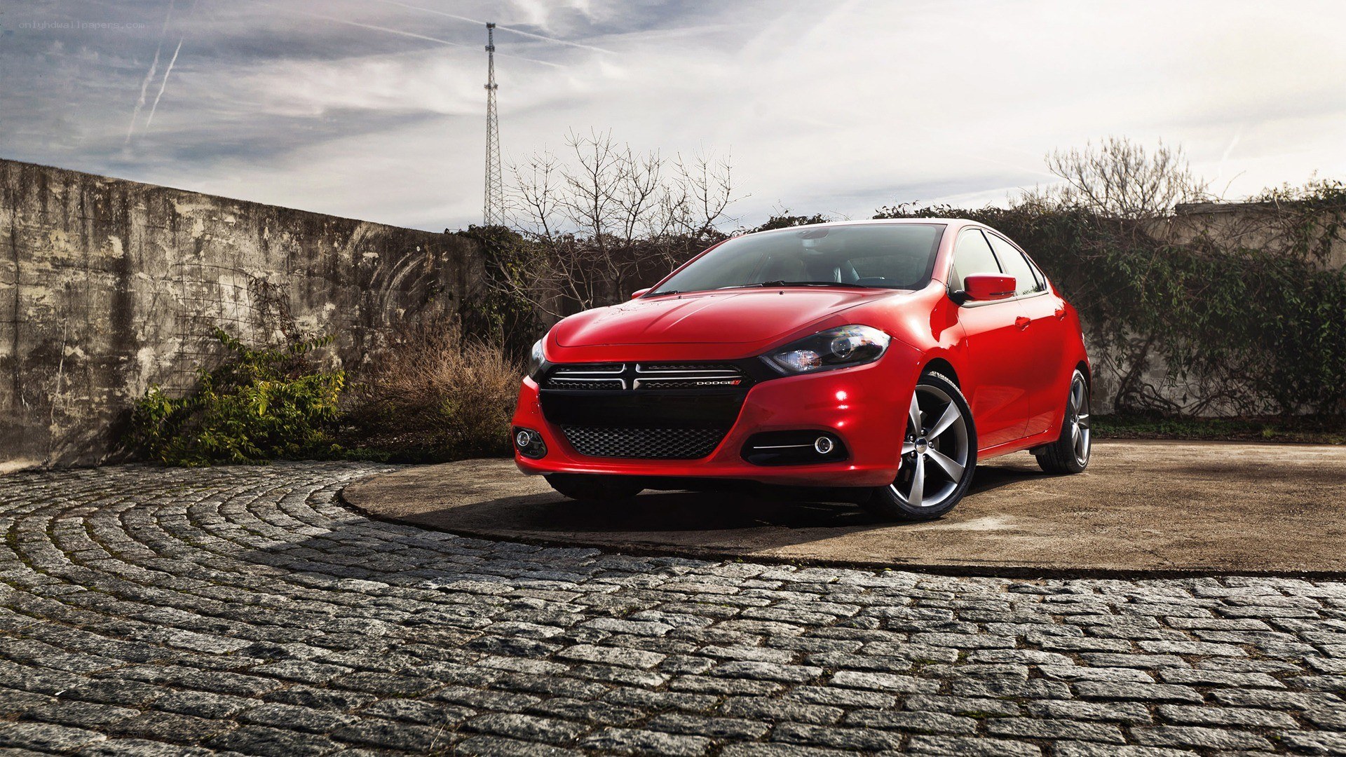 Red Dodge Dart on cobblestone