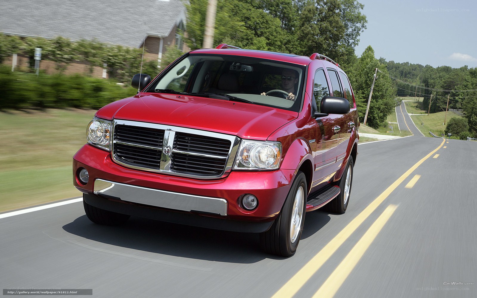 Red Dodge Durango driving on road
