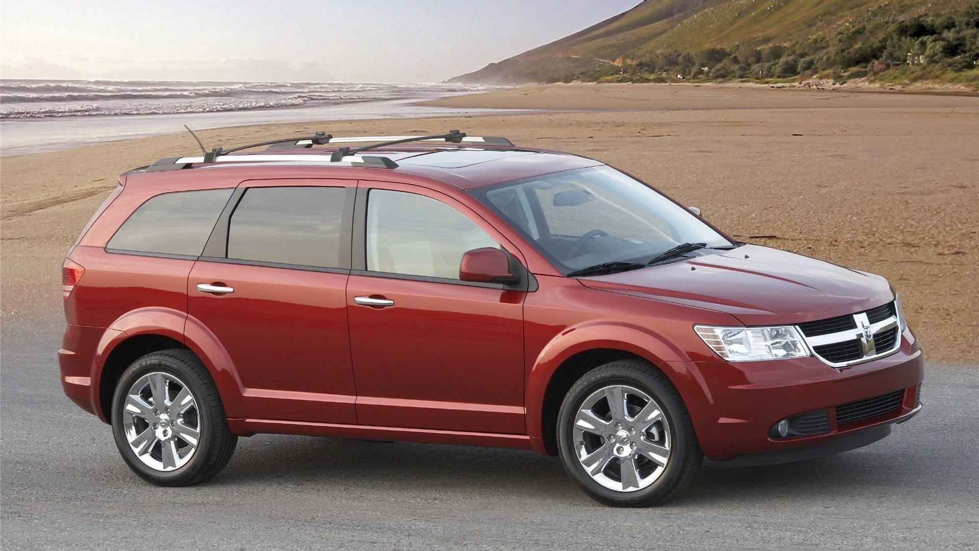 Red Dodge Journey on beach