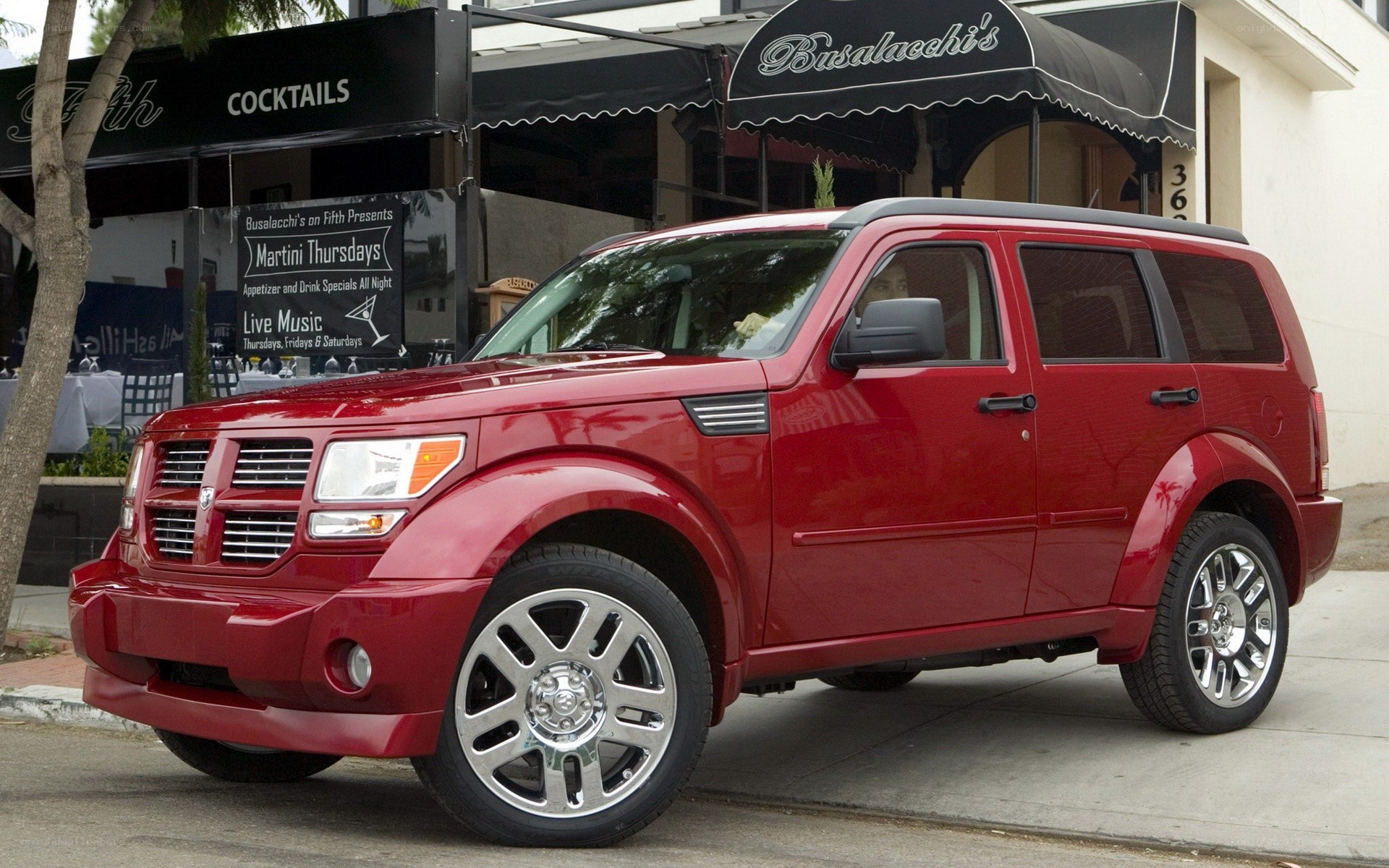 Red Dodge Nitro parked outside a restaurant