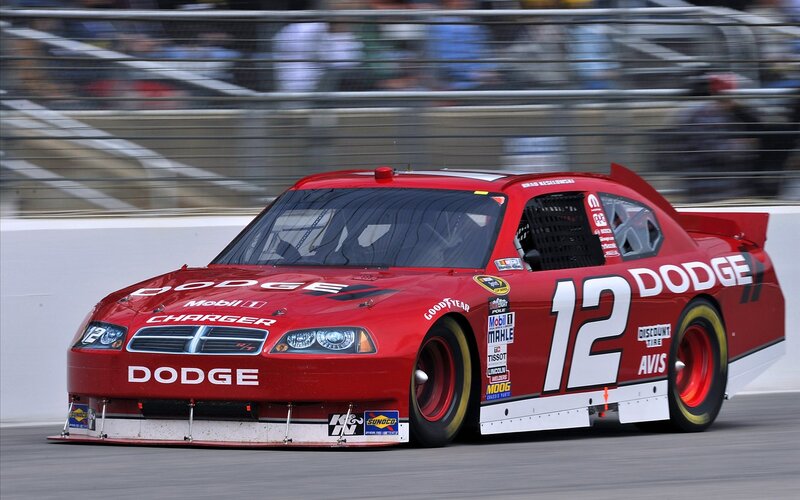 Red Dodge race car on track