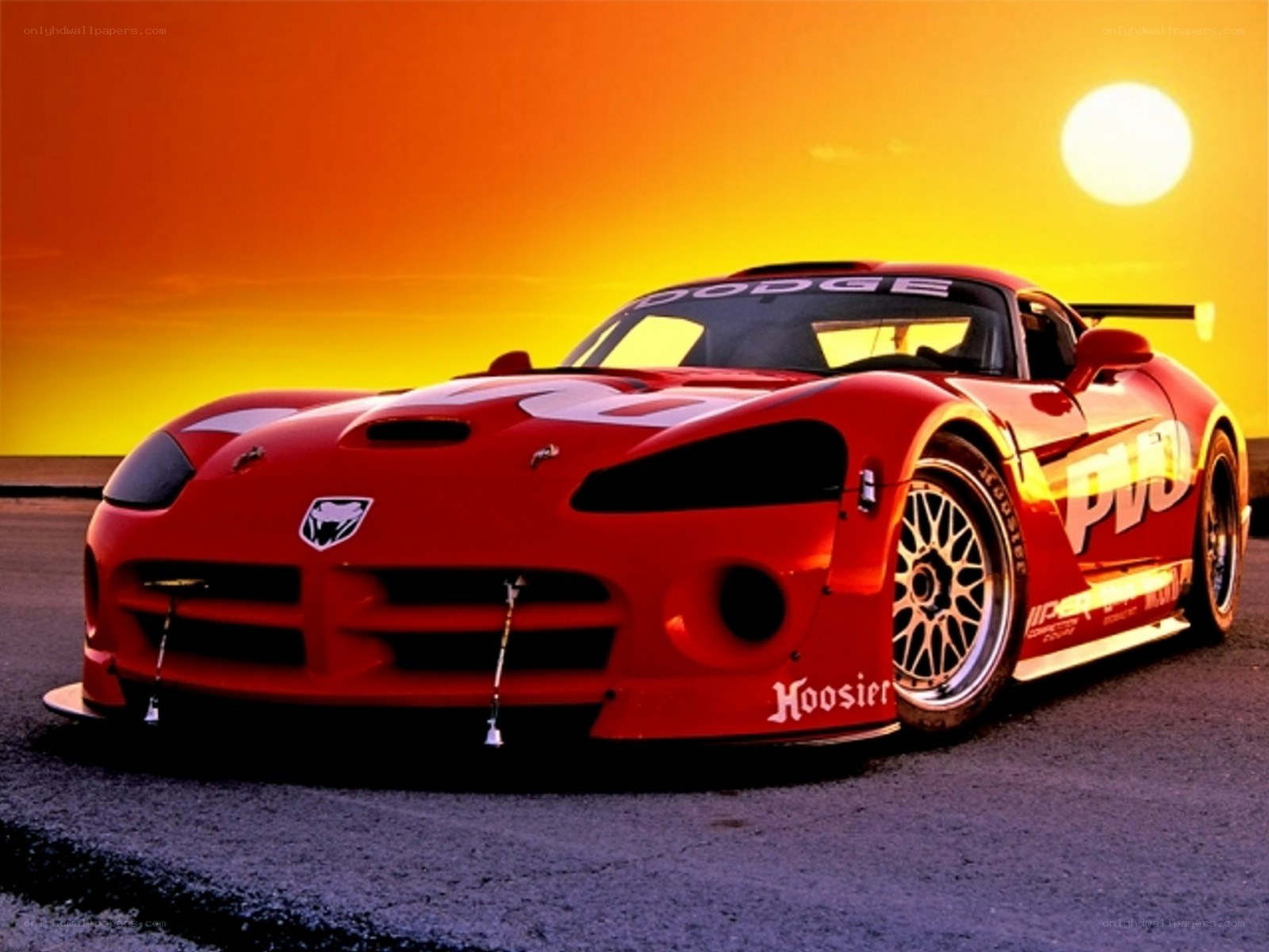 Red Dodge Viper race car at sunset