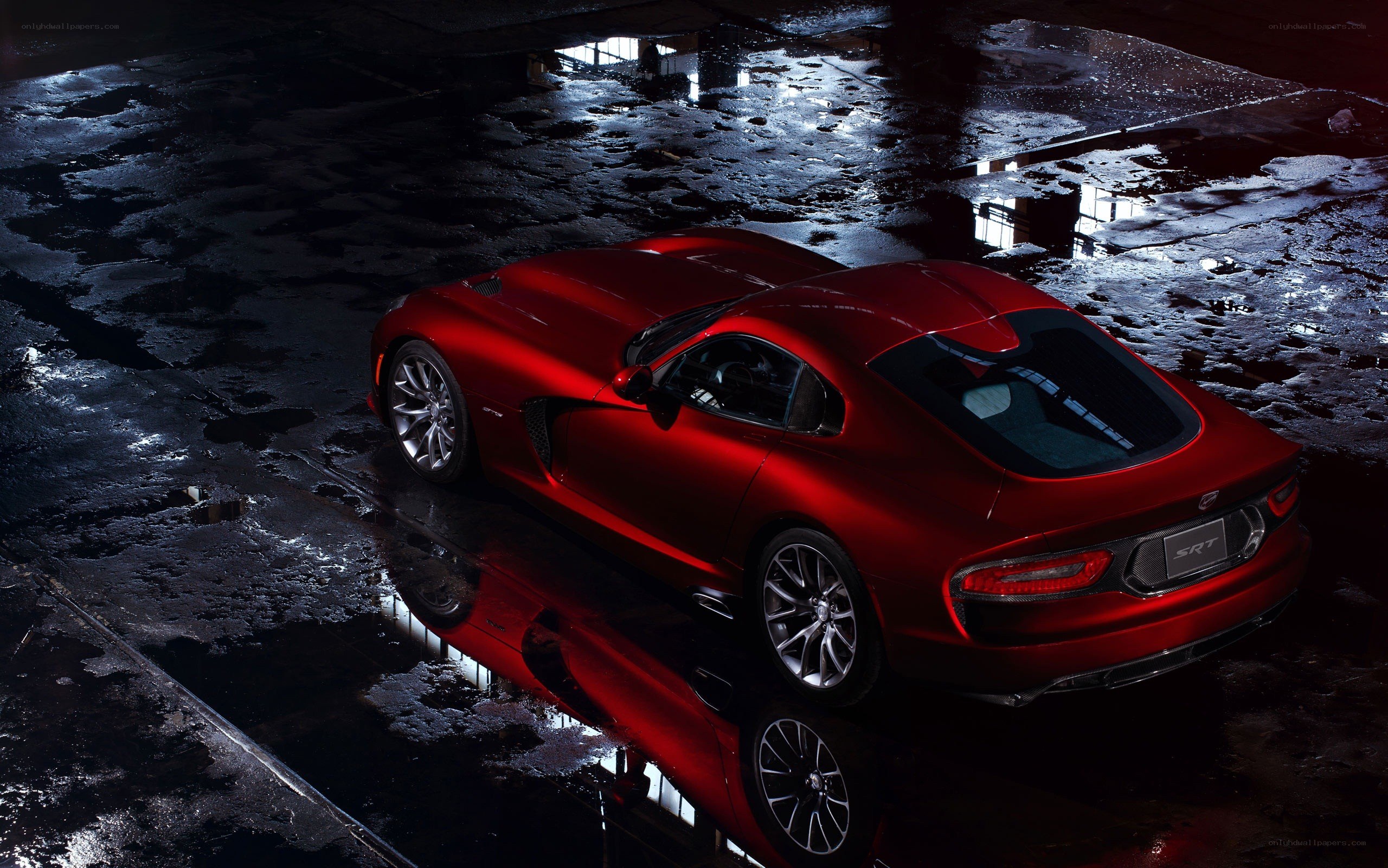 Red Dodge Viper SRT on wet pavement