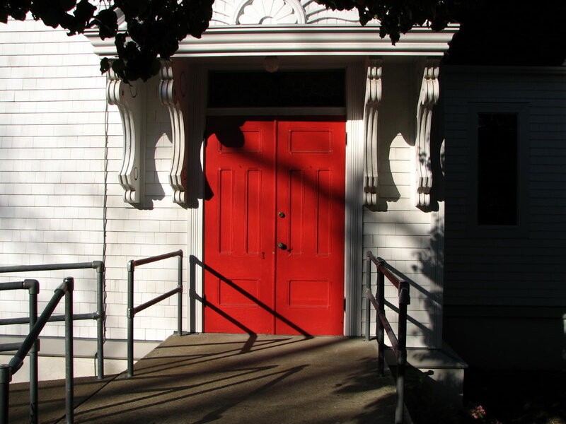 Red door on white building